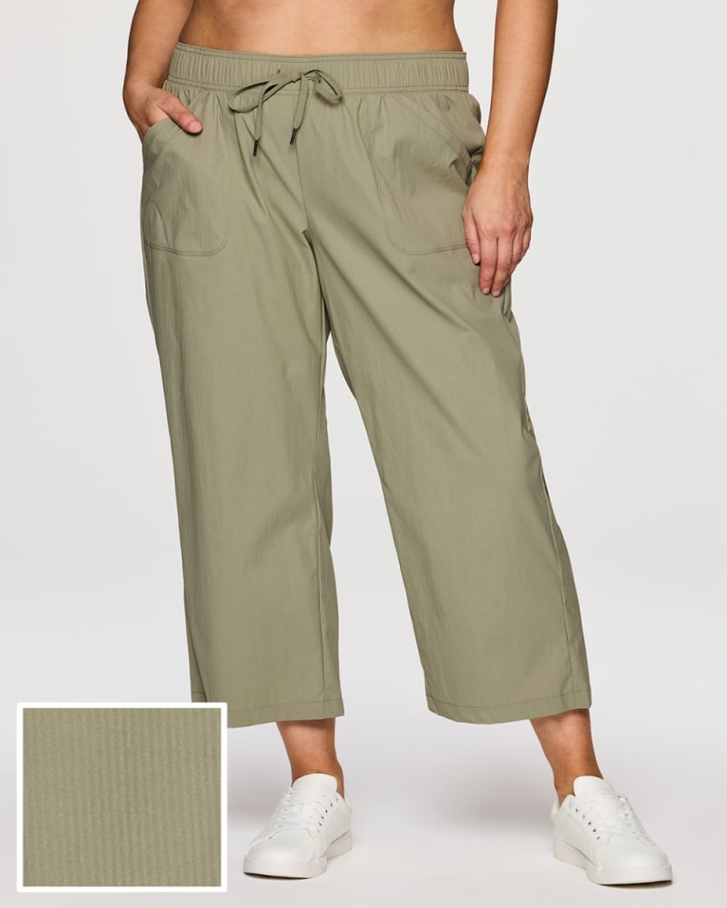 Front of a model wearing a size 1X Plus Birdie Everyday Ankle Pant in Olive by RBX Active. | dia_product_style_image_id:352935